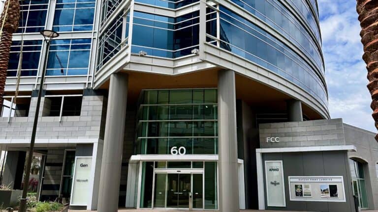 Contemporary modern office building with glass facade and clean architectural design, showcasing commercial real estate in a business district.