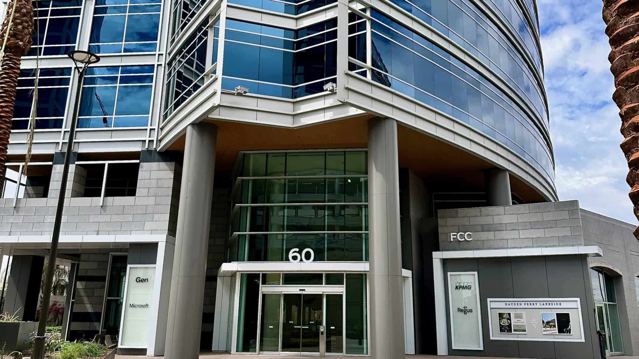 Contemporary modern office building with glass facade and clean architectural design, showcasing commercial real estate in a business district.