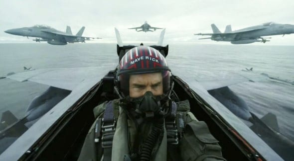Fighter jet pilot in cockpit with fighter jets flying overhead during military aviation training or air combat exercise.