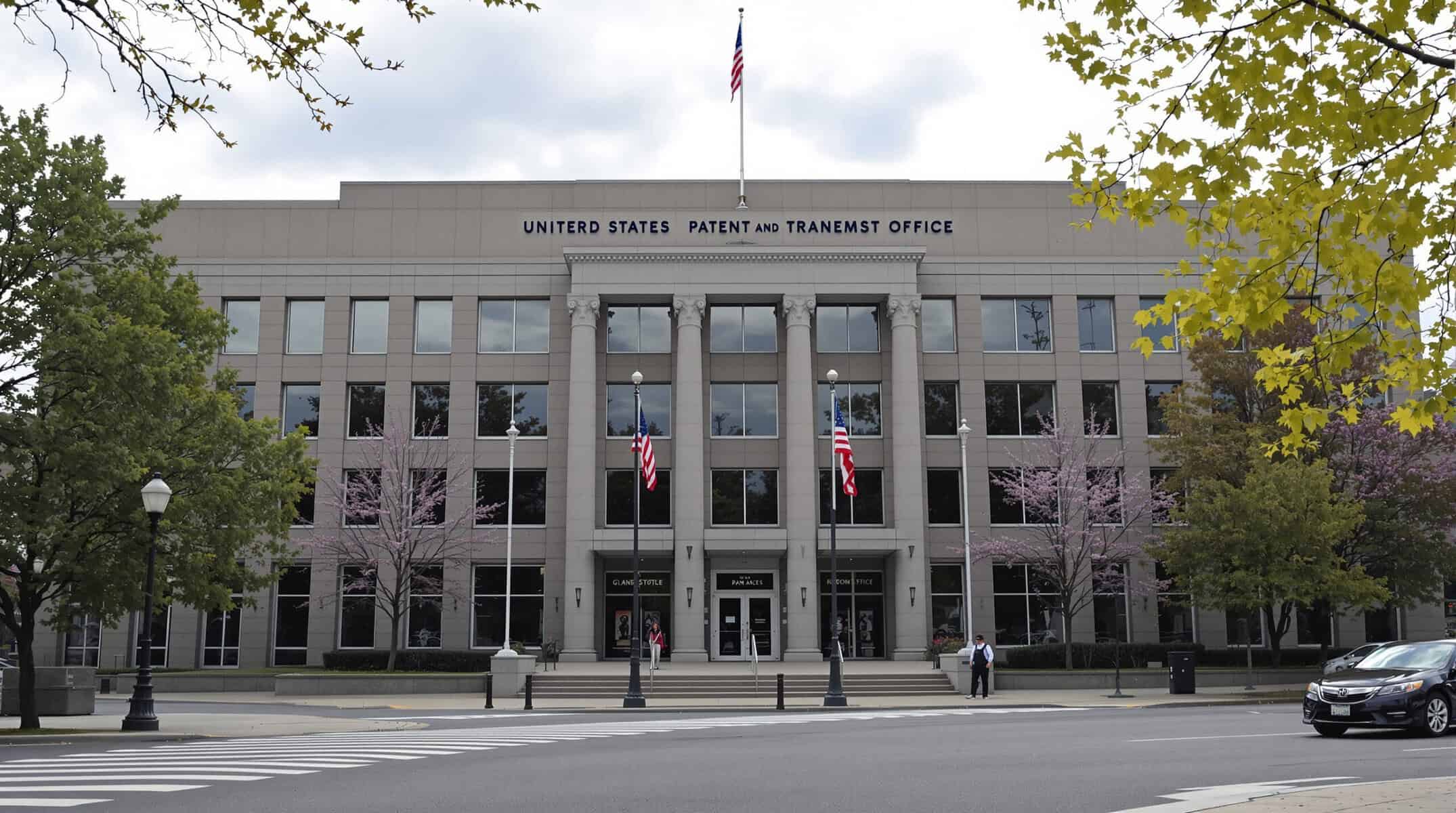 Modern US Patent and Trademark Office building with trees and flags, representing intellectual property and innovation.