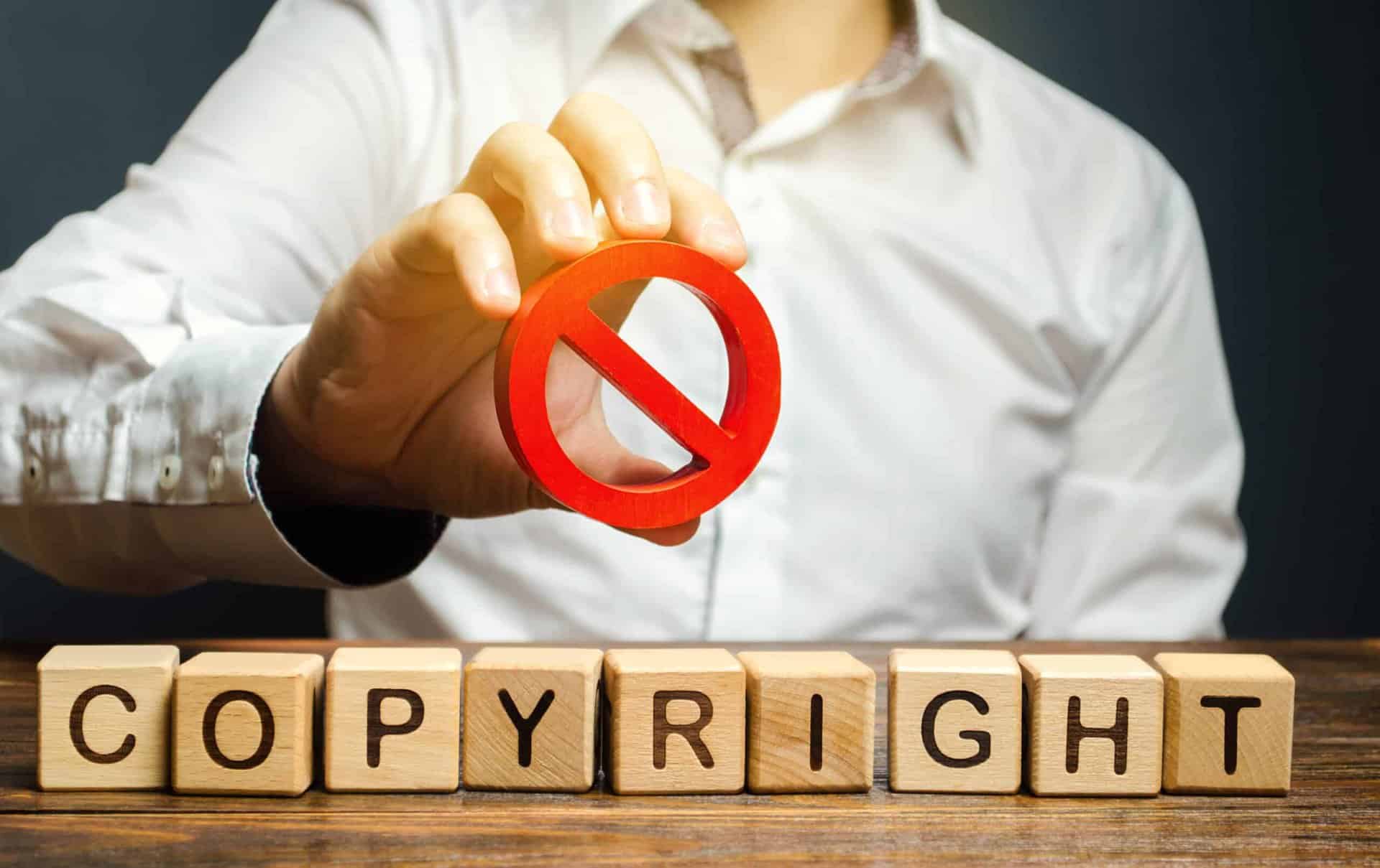Unauthorized copying and infringement of copyrighted content, symbolized by the red prohibition sign, emphasizing the importance of respecting licensing laws and protecting intellectual property rights.