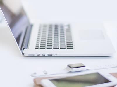 Modern laptop with keyboard and workspace accessories for tech innovation and business productivity.