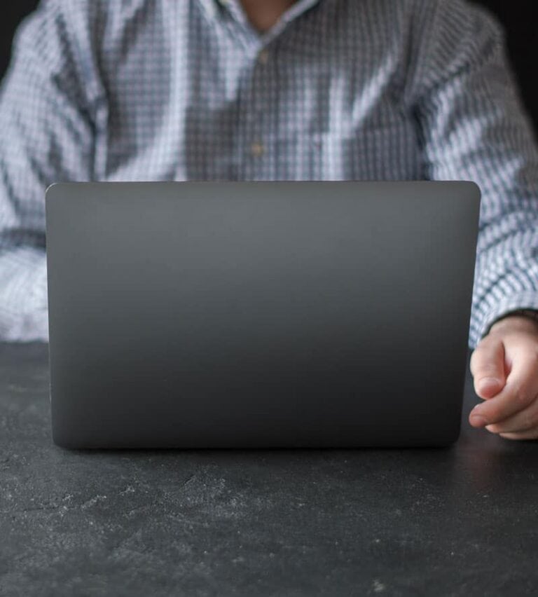 Modern person working on a sleek laptop in a professional environment, emphasizing technology and innovation.